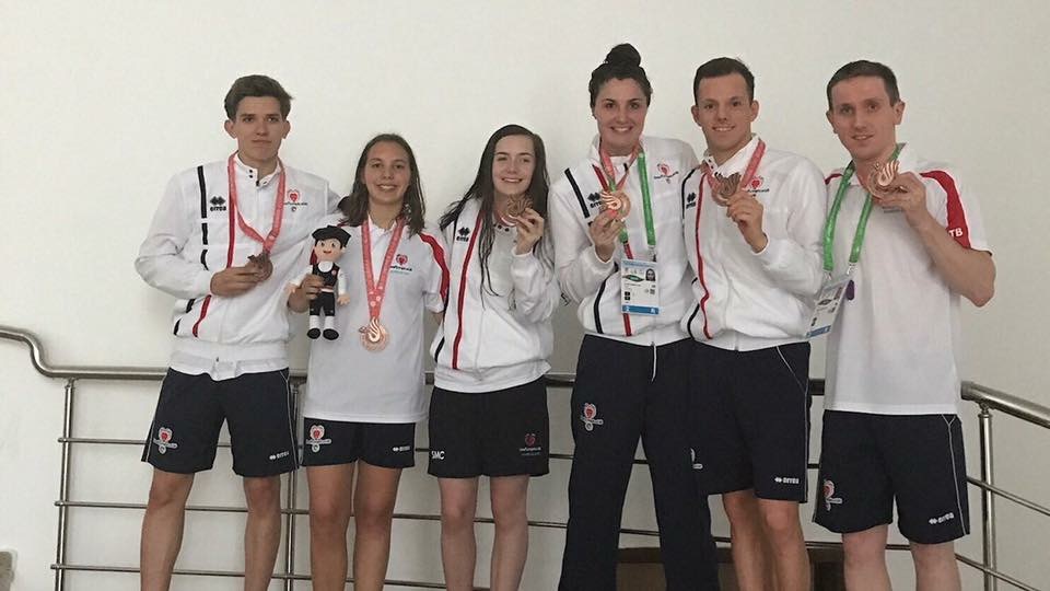 GB Deaf swimming team smiling with their Deaflympics medals
