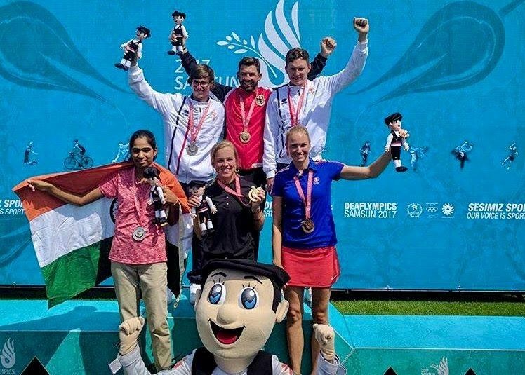 DeaflympicsGB athletes celebrating on medal podium