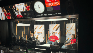 Athletes Charlotte Gower and Nathan Young are interviewed by host Gabby Logan inside a podcast studio